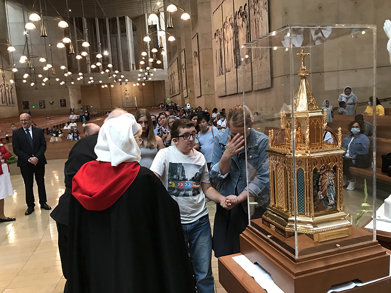 The faithful venerate the relics of St. Bernadette during their Aug. 2, 2022 stop at the Los Angeles cathedral.