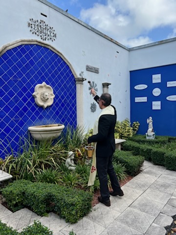Newly appointed parish adminstrator Father Luis Flores blesses an exterior courtyard at Sts. Peter and Paul School in Miami in preparation for the start of the 2022-23 school year.