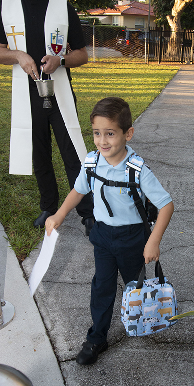 An eager Sts. Peter and Paul student walks to class on the first day of the 2022-23 school year, Aug. 17, 2022.