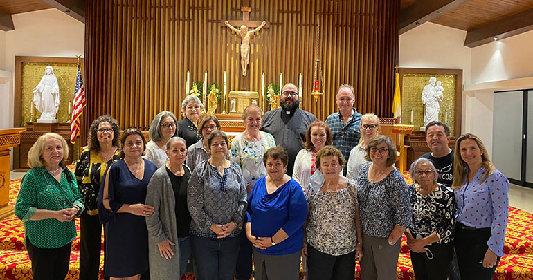 Serra Club members pose for a photo after their end-of-the-year membership meeting before the start of summer. With them, in back, is Father Matthew Gomez, archdiocesan director of vocations. The club won a $ 2,500 award this year for increasing membership to 94 members.