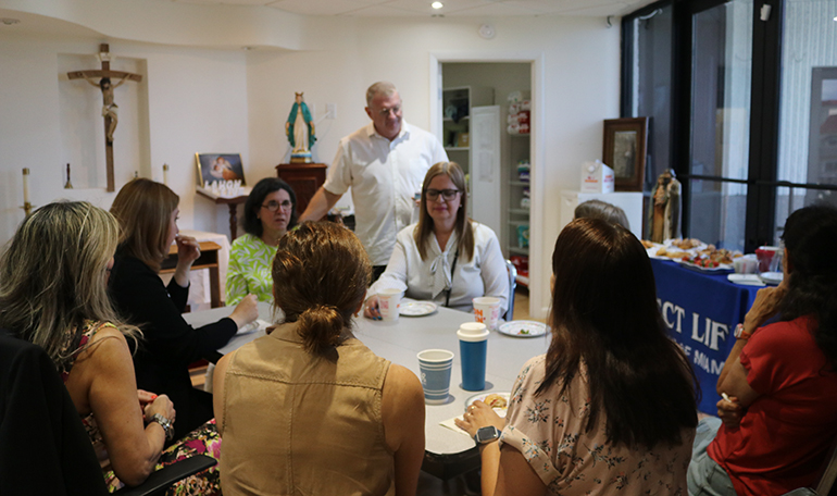 Deacon James Dugard of the Respect Life Ministry, speaks with the staff and volunteers of the ministry after the blessing of the new Central Broward Pregnancy Help Center, Aug. 13, 2022, in Fort Lauderdale.