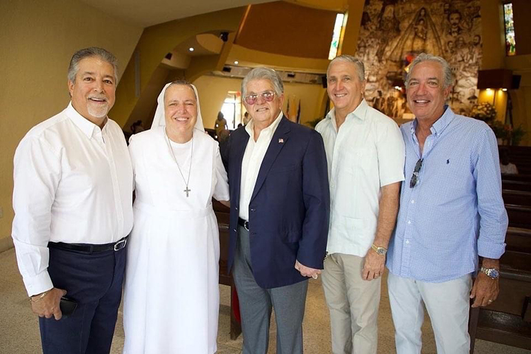 Posing after the Sept. 11, 2022 Mass with Salesian Sister Kim Keraitis, Immaculata-La Salle's principal, from left, are: Frank Ibarra, class of '75 and ILS Board of Trustees member; Max Alvarez, class of '65 and Pedro Pan; Ignacio Halley, class of '78 and president of the ILS Board of Trustees; and Jorge Guarch, class of '77, whose dad, George Guarch, would meet the Pedro Pan children at the airport and take them to the Church-run housing camps or waiting family members.