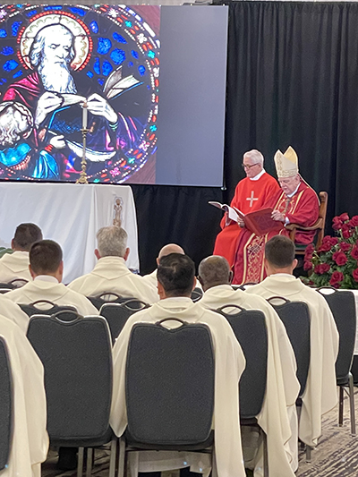 Nearly 200 archdiocesan priests take part in Mass with Archbishop Thomas Wenski on the second day of their annual convocation, which began the afternoon of Sept. 20 and concluded the morning of Sept. 22, 2022, at the Hyatt Regency in downtown Miami. The image behind the altar is that of St. Matthew, whose feast falls on Sept. 21.