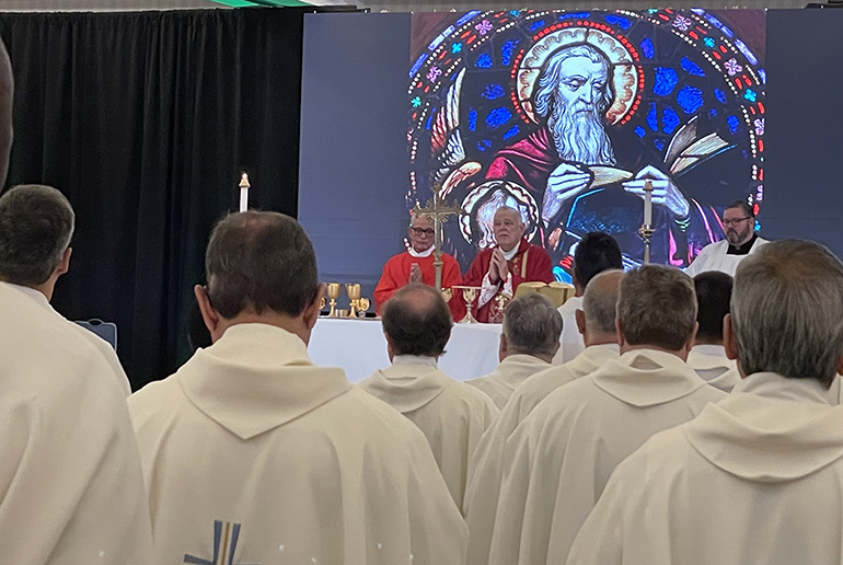 Nearly 200 archdiocesan priests take part in Mass with Archbishop Thomas Wenski on the second day of their annual convocation, which began the afternoon of Sept. 20 and concluded the morning of Sept. 22, 2022, at the Hyatt Regency in downtown Miami. The image behind the altar is that of St. Matthew, whose feast falls on Sept. 21.