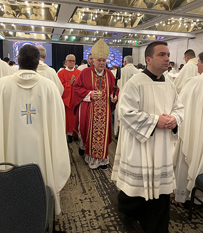 Archbishop Thomas Wenski exits the hall where he celebrated Mass with nearly 200 archdiocesan priests on the second day of their annual convocation, which began the afternoon of Sept. 20 and concluded the morning of Sept. 22, 2022, at the Hyatt Regency in downtown Miami.