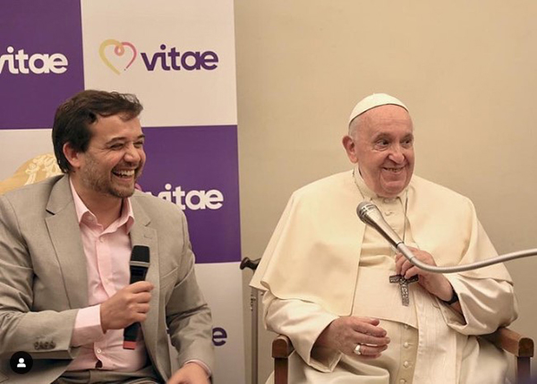 Luis Quinelli, founder of the Vitae Global Foundation, sits next to Pope Francis during his meeting with participants at the Vitae Summit 2022 in the Vatican, Sept. 1, 2022.