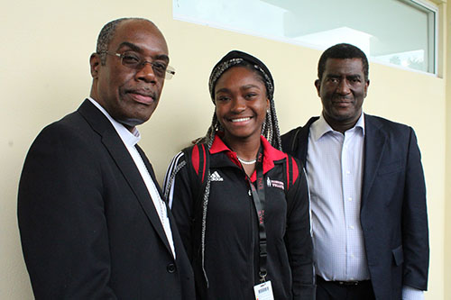 La estudiante de la secundaria Msgr. Edward Pace, Chesley Gachette posa con el Obispo Charles Peters Barthélus de Port-de-Paix, Haití (izquierda), y Marc St. Louis, durante la visita del obispo a la escuela en Miami Gardens, el 14 de septiembre de 2022.