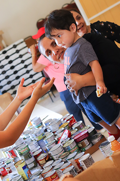 Volunteers and members of the local community turned out by the thousands Oct. 4, 2022 at the food pantry at Jesús Obrero (Jesus the Worker) Parish northwest of downtown Fort Myers after Hurricane Ian passed over southwest Florida a week earlier. The parish serves many of the laborers who are likely to play a role in rebuilding the region, according to the pastor here.