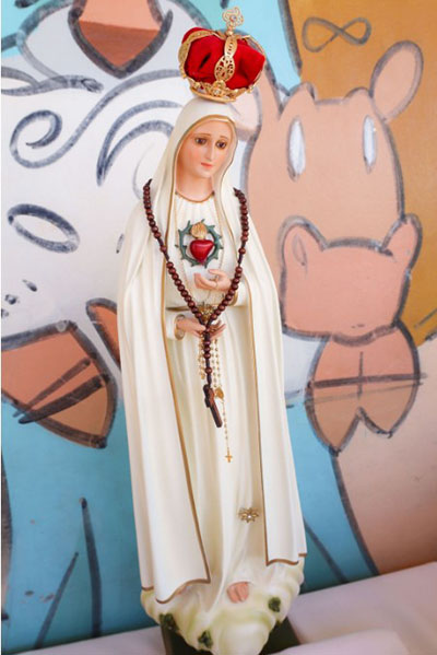 Students at Our Lady of the Holy Rosary-St. Richard School placed flowers in front of this image of Our Lady of the Holy Rosary to mark the feast of the Holy Rosary, Oct. 7, 2022.