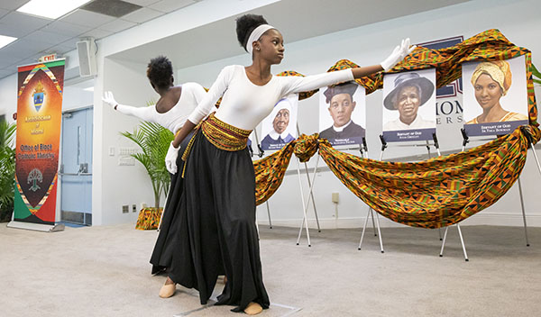 Members of the Praise Angel Dancers from St. Philip Neri Church perform during the Black Catholic History Month luncheon, held at St. Thomas University on Nov. 19, 2022. From left are Abby Warner and Kalani Kerr.