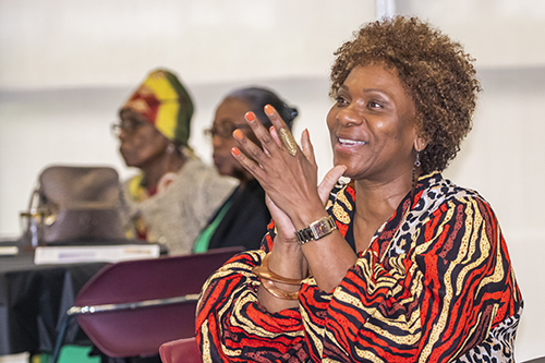 Carline Faublas, parishioner at San Isidro Church in Pompano Beach, cheers during the Black Catholic History Month luncheon, held at St. Thomas University on Nov. 19, 2022.