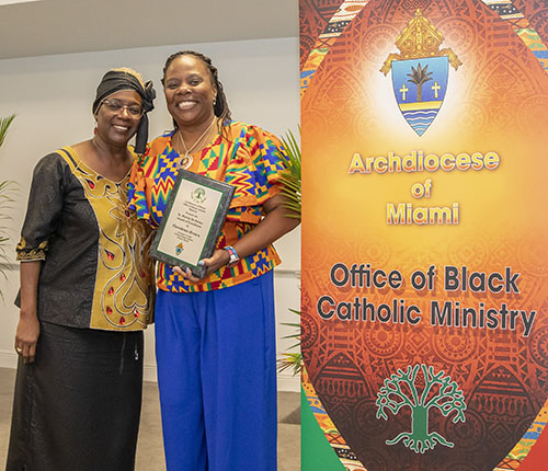 Katrenia C. Reeves-Jackman, left, director of the Office of Black Catholic Ministry, poses with this year's recipient of the St. Martin de Porres Award, Floredenis Brown, principal of Holy Rosary-St. Richard School in Palmetto Bay. The luncheon was held at St. Thomas University on Nov. 19, 2022.