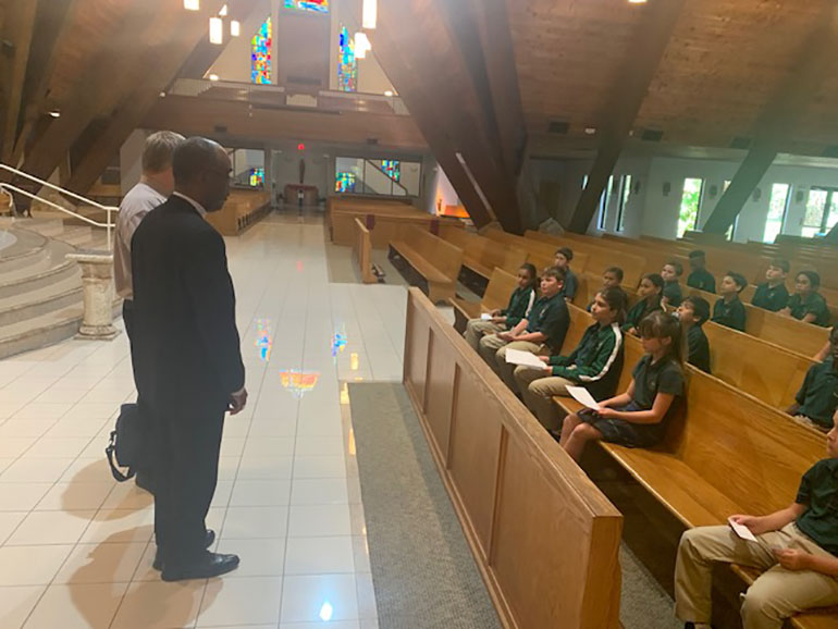 Bishop Charles Peters Barthélus of Port-de-Paix, Haiti, speaks with fifth graders during his October 2022 visit to St. David School in Davie.