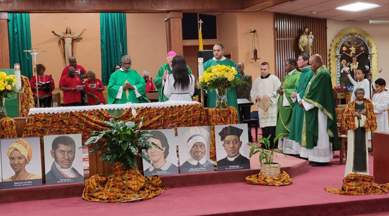 Archbishop Thomas Wenski celebrates Mass at St. Stephen Church in Miramar to mark the start of Black Catholic History Month, Nov. 5, 2022. In front are images of Black Catholics from the U.S. currently being proposed for sainthood.