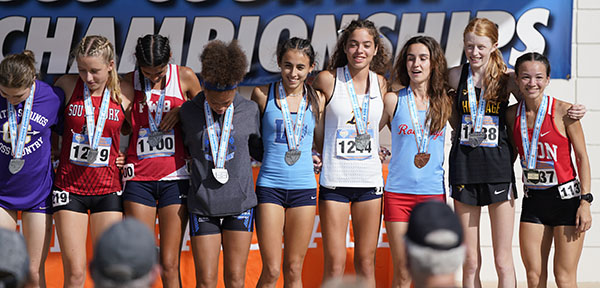 Runner Olivia Fraga, fifth from left, from Lourdes Academy stands next to St. Thomas Aquinas' Grace Finnerman (#1244) along with other top Class 3A finishers at the Florida High School Athletic Association's State Cross Country Championships, held Nov. 5, 2022 in Tallahassee.
