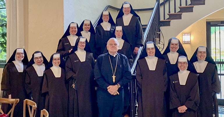 Archbishop Thomas Wenski poses with the Carmelites of the Most Sacred Heart of Los Angeles who work in the Archdiocese of Miami after blessing and dedication their new convent near Little Flower Church in Coral Gables, Nov. 21, 2022.
