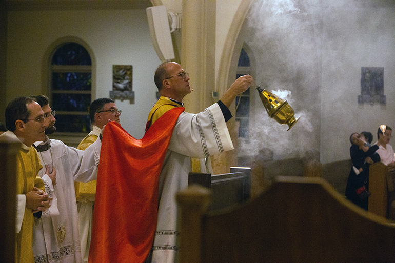 Father Christopher Marino, St. Mary Cathedral's rector, incenses the monstrance containing the Eucharist while leading a Viva Cristo Rey procession in honor of the solemnity of Christ the King, Nov. 20, 2022.