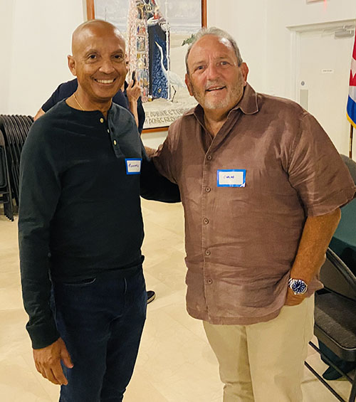 University of Miami police officer Richard Williams, left, and Carlos Sotomayor chat at the first meeting of Frontline Ministry, this past August, at St. Augustine Church in Coral Gables. The ministry seeks to provide fellowship and Catholic formation to badge-wearing first responders serving across Miami-Dade County, be they military, firefighters, police officers or public safety telecommunicators.