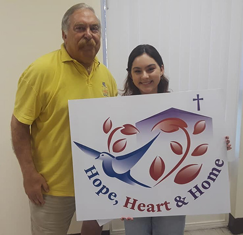 Eric Schwindeman, founder of the Hope, Heart and Home ministry, poses with Lillian Byrd, a first-year graphic artist
student at NYC School of Visual Arts and a member of St. Catherine of Siena Church in Miami, who was commissioned to design a new logo for the ministry.