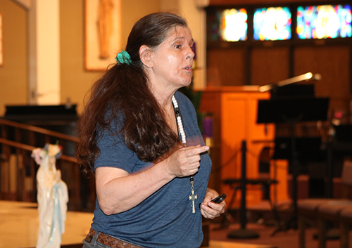 Vicky Yardley, who heads the S.E. Chapter of the Columbiettes, greets people attending the first evening of the Archdiocese of Miami Rosary Congress, held Dec. 2, 2022 at St. Gabriel Church in Pompano Beach. The event, sponsored by the Columbiettes, was held over seven days at six parishes and included Mass, rosary prayer and 24 hours of adoration before the Blessed Sacrament.