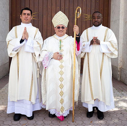 Deacons Julio Cesar Vazquez, left, and Rikinson Bantou pose for a photo with Auxiliary Bishop Enrique Delgado, who ordained them to the deaconate Dec. 3, 2022 at St. Mary Cathedral in Miami. The deaconate is the last step before their ordination to the priesthood.