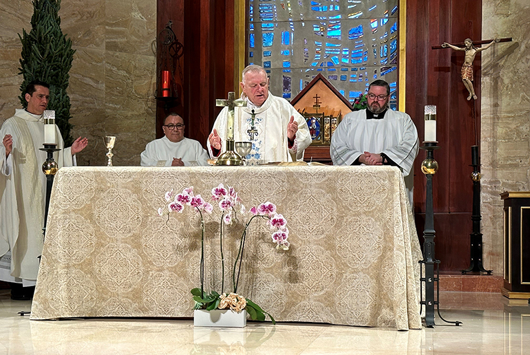 Archbishop Thomas Wenski celebrates Mass on the feast of the Immaculate Conception at St. Martha Church, located next door to the archdiocesan Pastoral Center, Dec. 8, 2022. With him, from left, are Father Juan Carlos Salazar, administrator of St. Martha; Deacon Edgardo Farias, director of the archdiocese's Detention Ministry; and Father Ryan Saunders,the archbishop's priest secretary.