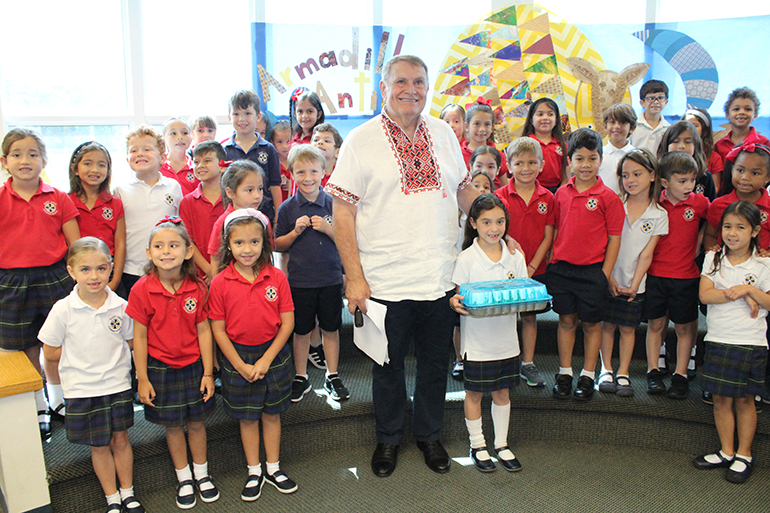 Children's author Michael Sampson poses with students from St. Louis Covenant School in Pinecrest on April 29, 2022, after presenting his book "Armadillo Antics." Sampson also visited middle school students at the school and discussed his work as a Fulbright Scholar in Ukraine, which turned into humanitarian work with refugees fleeing the country.