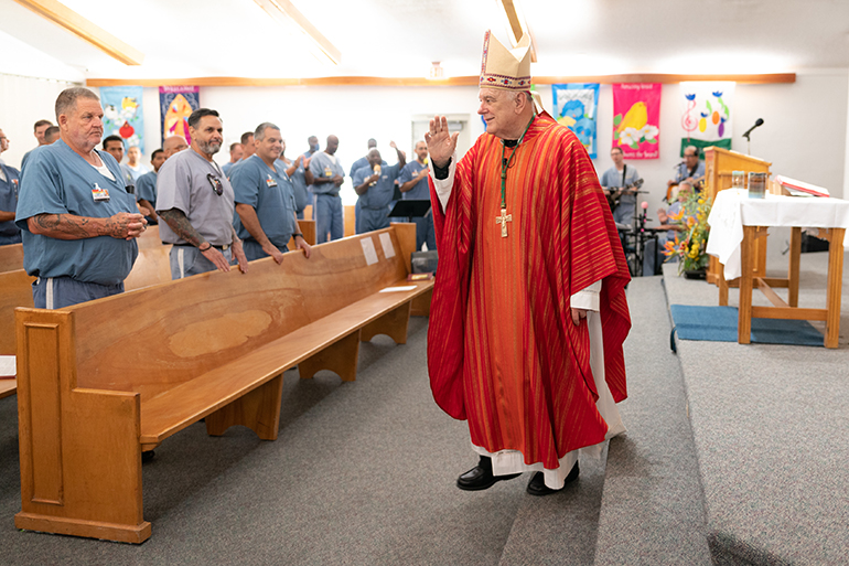 Miami Archbishop Thomas Wenski blesses inmates after celebrating Mass June 8, 2022 during a pastoral visit at Everglades Correctional Institution in the western edge of Miami-Dade County. The facility runs an incentivized pilot program to cultivate an environment of learning and rehabilitation in order to reduce violent behavior among inmates. The prison is also unique in that it has a fulltime Catholic chaplain.