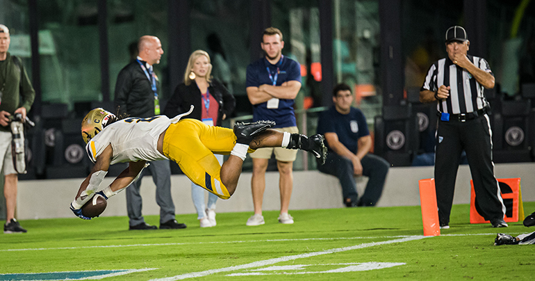 St. Thomas Aquinas running back Jordan Lyle lunges for the end zone to score the Raiders first touchdown on their way to winning their fourth consecutive, and 14th overall, state championship. They defeated Homestead 38-21 in the Class 3M final, Dec. 15, 2022 in Fort Lauderdale.