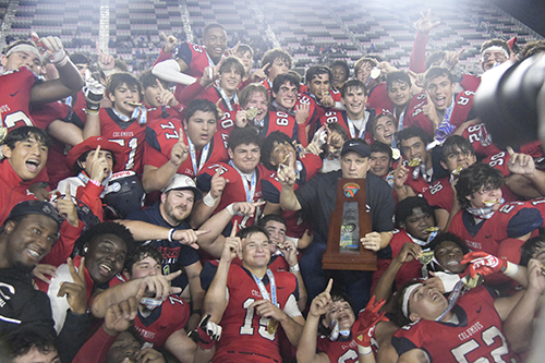 Columbus High Explorers and head coach Dave Dunn celebrate their second state championship, an overtime 16-13 win against Apopka in the Class 4M final, Dec. 17, 2022 in Fort Lauderdale.