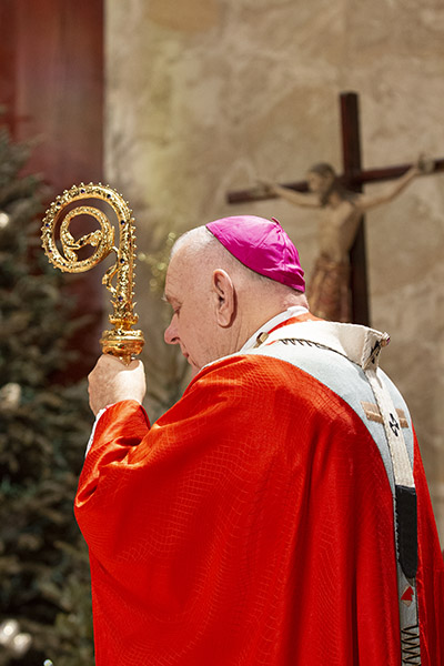 Archbishop Thomas Wenski listens to the Gospel while celebrating a memorial Mass for Pope emeritus Benedict XVI on the same day of his funeral in Rome, Jan. 5, 2023. The Mass was celebrated at St. Martha Church in Miami Shores, next door to the Pastoral Center. Pope Benedict XVI died Dec. 31, 2022.