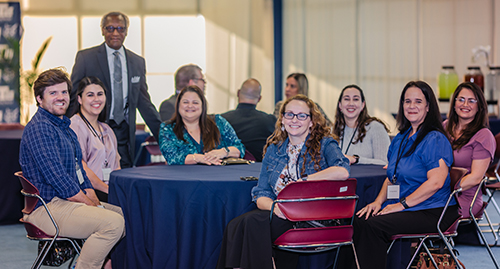 Some of the 14 archdiocesan educators who make up the first cohort of students in the master's in educational leadership program for future Catholic school principals pose with Donald Edwards, standing, associate superintendent of Catholic schools, during a kickoff event at St. Thomas University in Miami Gardens, Jan. 8, 2023.