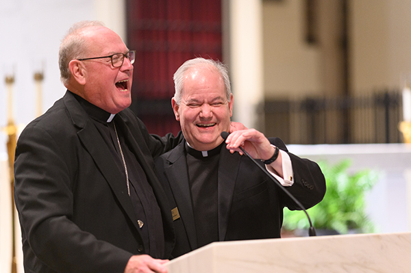 Cardinal Timothy Dolan of New York shares a laugh with Father Alfredo Hernandez, right, rector of the seminary, after delivering a lecture on "Used-to-be Catholicism" Jan. 19, 2023, at St. Vincent de Paul Regional Seminary in Boynton Beach, Florida.