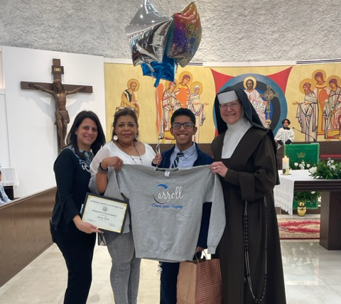 Johandry Escobar, who received the highest score in Archbishop Coleman Carroll High School's placement exam, poses with his mother, Marlene Barbarena, Carmelite Sister Margaret Ann, Archbishop Carroll's principal, and Yesy De La Torre, far left, principal of Mother of Christ School.