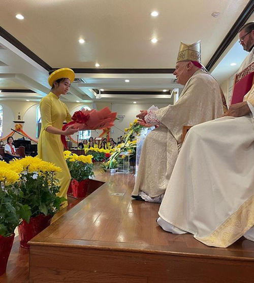 Archbishop Thomas Wenski receives an offertory gift during the Mass marking the Vietnamese celebration of Tet, the new year, Jan. 22, 2023 at Our Lady of La Vang Vietnamese Mission in Hallandale Beach.