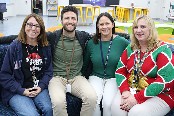 Principal Lori St. Thomas (far right)  gathers with members of her teaching team to talk about technology advancements, academic accomplishments and new goals as St. Coleman School celebrates its 65th anniversary in 2023 with a new recognition as an Apple Distinguished School, Shown are teachers Patricia O'Connor, (far left) Tyler Withrow and Laura Thomas.