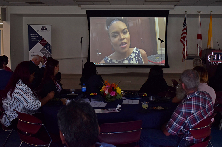 Attendees watch the documentary "Trapped" during the annual Gillen-Massey award luncheon at St. Thomas University on Feb. 8, 2023.