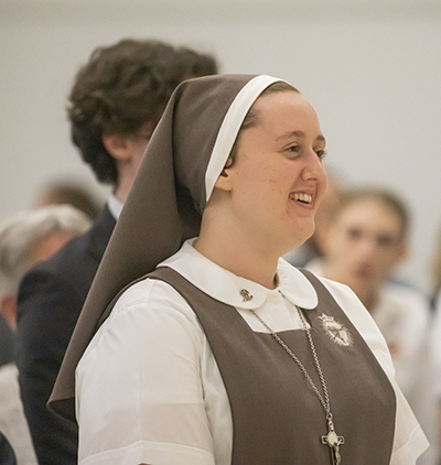 Sister Lucy Clare of the Triumph of the Church smiles during the Mass of first vows as a member of the Servants of the Pierced Hearts of Jesus and Mary, Feb. 2, 2023.
