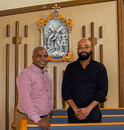 Berthony Seize and Camille Rosette, Haitian sculptors who created the new Stations of the Cross at St. Helen Church in Lauderdale Lakes, stand in front of the eighth station. Archbishop Thomas Wenski consecrated a new altar and installed Father Lucien Pierre as pastor of the Lauderdale Lakes church, Jan. 21, 2023.