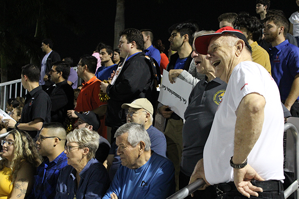 Archbishop Thomas Wenski enjoys the game while standing with the seminarians' cheering section. Partly visible next to him is Msgr. Pablo Navarro, rector of St. John Vianney College Seminary in Miami. Archdiocesan seminarians defeated the priests 3-0 in the inaugural Archbishop's Cup soccer game, played Feb. 3, 2023 on the field at St. Thomas University, Miami Gardens.