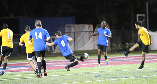 Father Juan Carlos Salazar (8) clears a shot from seminarian Deacon Saul Araujo. Archdiocesan seminarians defeated the priests 3-0 in the inaugural Archbishop's Cup soccer game, played Feb. 3, 2023 on the field at St. Thomas University, Miami Gardens.