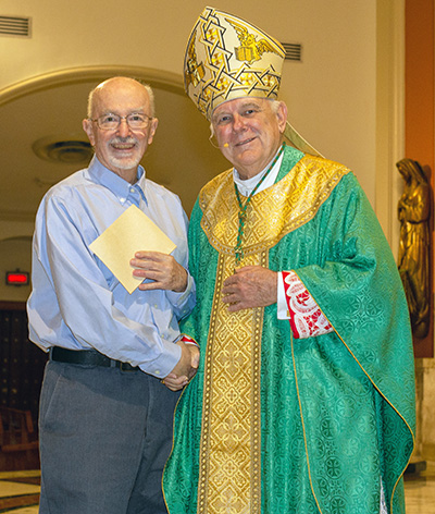Archbishop Thomas Wenski presents a certificate of appreciation to Brother Robert Koppes, who is marking 60 years with the Edmund Rice Christian Brothers, during the celebration of the World Day for Consecrated Life, Feb. 4, 2023 at St. Mary Cathedral.