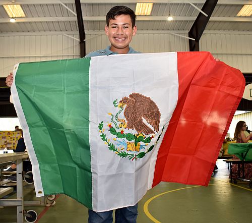 Seventh-grader John Richards proudly spreads his Mexican flag at St. David School's cultural festival Feb. 5.