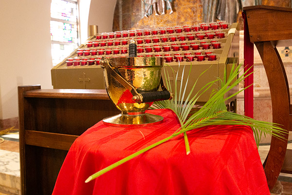 Palms and holy water rest on a stand in a side altar of St. Mary Cathedral in this file photo. The majority of palm branches used in North American churches for Palm Sunday come from the Florida Everglades, undeveloped Florida land, Texas, and the Gulf Coast of Mexico.