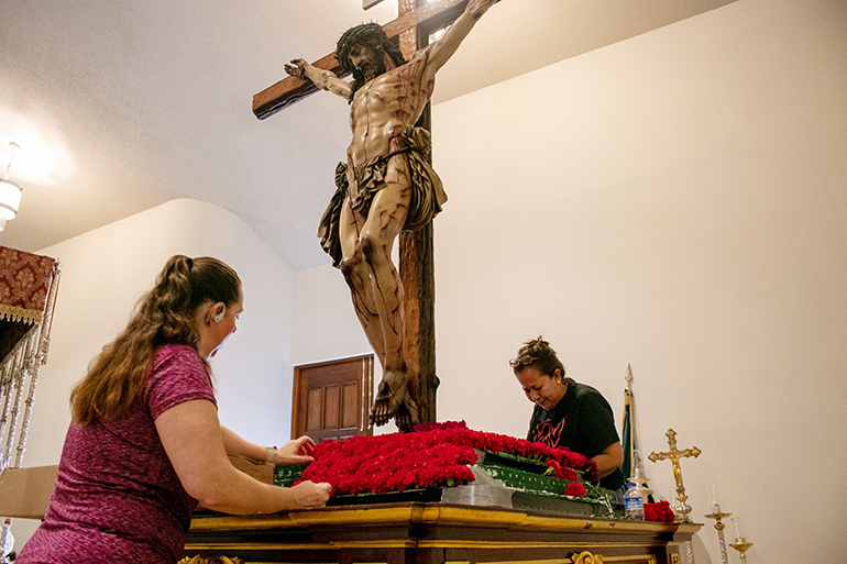 Volunteers from Corpus Christi Parish in Miami decorate the platform of the Cristo de la Misericordia (Christ of Mercy) for the Good Friday procession on April 15, 2022. The cedar sculpture made by Juan Manuel Miñarro is one of only two such pieces in the world.