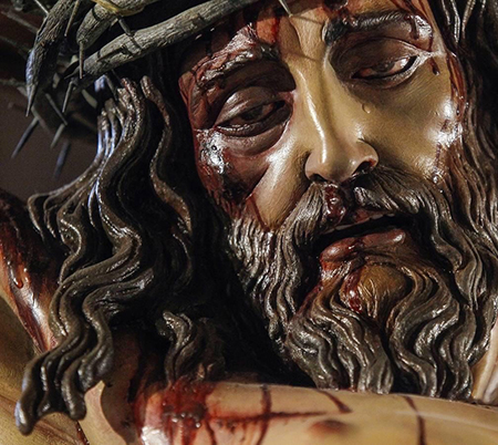 Close-up of the face of the Cristo de la Misericordia (Christ of Mercy), a sculpture carved in cedar by Juan Manuel Miñarro. It is one of only two pieces in the world and vividly reproduces the injuries and wounds inflicted on Christ as revealed by the Shroud of Turin and the Sudarium of Oviedo. It was made for Corpus Christi Parish in Miami and taken out in procession for the first time on Good Friday 2022.