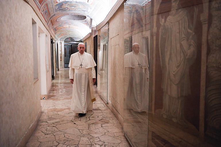 Pope Francis walks through the crypt of St. Peter's Basilica as he visits the tombs of deceased popes at the Vatican on All Souls' Day, Nov. 2, 2020. In a 2023 interview marking the 10th anniversary of his election, the 86-year-old pope insisted it is not his task to make an accounting of what he has or has not accomplished since March 13, 2013. "The Lord will do the appraisal when he sees fit."