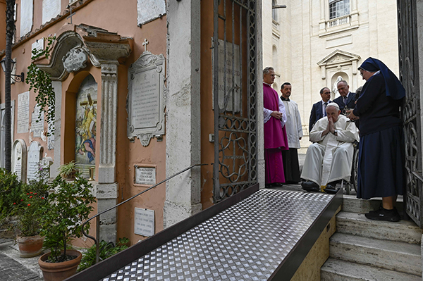 Pope Francis prays at the entrance to the Vatican's Teutonic Cemetery, a medieval cemetery now reserved mainly for German-speaking priests and members of religious orders, during a visit Nov. 2, 2022, the feast of All Souls. In an interview for the 10th anniversary of his pontificate March 13, 2023, the 86-year-old pope said he thinks about death often, because it is a good thing to remember one will not live forever. (CNS photo/Vatican Media)