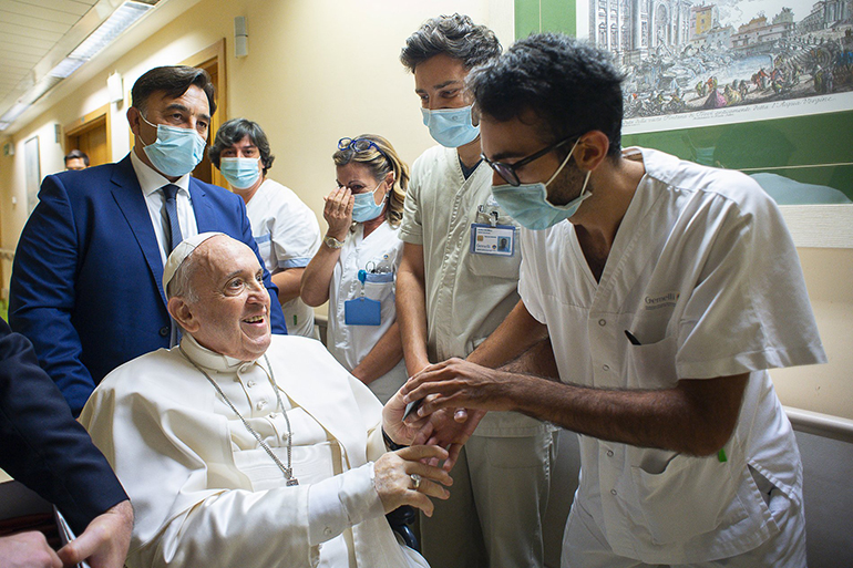 Pope Francis greets hospital workers at Gemelli hospital in this file photo taken in Rome July 11, 2021, when the pope had been in the hospital for 10 days to recover from a scheduled colon surgery. (CNS photo/Vatican Media)