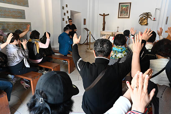 Pilgrims to the Holy Land pray at the Stella Maris chapel in Mount Carmel, Israel, where tradition holds that the prophet Elijah defeated the prophets of Baal. Tourism to Israel and the Holy Land has rebounded following the global pandemic and lockdowns that began in 2020, but the ongoing war between Russia and Ukraine has presented other setbacks.